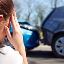 Stressed Driver Sitting At Roadside After Traffic Accident