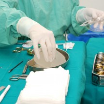 Nurse with operating tools and chest implants